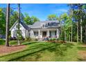 Charming white farmhouse-style home with inviting front porch at 165 Alpine Rd, Moncure, NC 27559