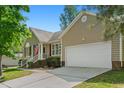 Attractive one-story home showcasing an attached garage, brick foundation, and a well-maintained driveway at 1998 Ferbow St, Creedmoor, NC 27522