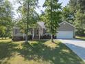 Traditional home featuring a well-manicured lawn, an attached garage, and inviting curb appeal at 1998 Ferbow St, Creedmoor, NC 27522