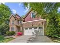Charming two-story home with stone and shingle facade, attached garage, and beautifully landscaped front yard at 208 Bellagio Dr, Apex, NC 27539