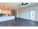 Bright living space with stylish light fixture, gray wood flooring, and open layout at 2205 Gathering Square Ct, Fuquay Varina, NC 27526