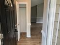 Inviting foyer with wood-look flooring and a coat closet upon entry into the home at 284 Irvan St, Clayton, NC 27520