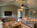 Inviting living room featuring vaulted ceilings, wood floors, and stylish decor at 284 Irvan St, Clayton, NC 27520
