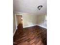 Spacious living room with rich hardwood floors and a view into the kitchen at 304 Culvert St, Apex, NC 27502