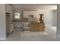An unfinished kitchen features white cabinets and a center island frame, offering a customizable space at 328 Green Pines Estates Dr, Kenly, NC 27542