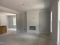 An unfinished living room features a modern fireplace accent wall and ample natural light from a large window at 328 Green Pines Estates Dr, Kenly, NC 27542