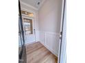 Inviting entryway with paneled wall accents, wood-look flooring, and a glass front door at 355 Beacon Hill Rd # 23, Lillington, NC 27546