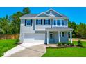 Charming two-story home with a well-manicured lawn and a classic architectural style at 355 Beacon Hill Rd # 23, Lillington, NC 27546