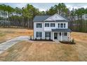 Charming two-story home with a well-manicured lawn and a long driveway at 355 Beacon Hill Rd # 23, Lillington, NC 27546