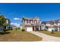 Beautiful two-story home featuring red shutters, a front-facing garage, and professionally landscaped yard at 3629 Brittlebank Dr, Raleigh, NC 27610