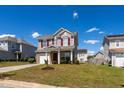 Attractive two-story home boasts red shutters, a front garage, and a lush, green lawn at 3629 Brittlebank Dr, Raleigh, NC 27610