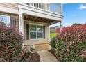 Inviting front porch with decorative bushes and a charming dinosaur statue at 3832 Stovall Dr, Haw River, NC 27258