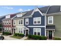 View of colorful townhomes with well-maintained lawns and landscaping at 433 Triumph Ln, Wake Forest, NC 27587