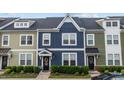 Charming townhome with blue siding, white trim, and well-manicured landscaping at 433 Triumph Ln, Wake Forest, NC 27587