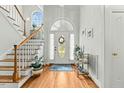 Bright foyer with hardwood floors, staircase, and decorative wreath on front door at 480 Whitt Ave, Burlington, NC 27215