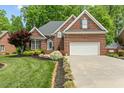 Charming brick home with a manicured lawn, two-car garage, and elegant landscaping at 480 Whitt Ave, Burlington, NC 27215
