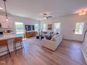 Bright and airy living room with comfortable seating, a modern entertainment center, and wood-look flooring at 499 Beacon Hill Rd # 30, Lillington, NC 27546