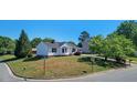 Corner lot featuring a well-maintained lawn and charming home with a classic design at 500 Lemontree Ct, Graham, NC 27253