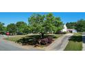 Landscaped lawn with mature trees and a long driveway leading to a charming home at 500 Lemontree Ct, Graham, NC 27253