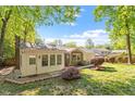 Backyard of brick house featuring mature trees and landscaping at 5713 Old Forge Cir, Raleigh, NC 27609