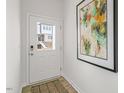 Inviting entryway featuring a stylish front door with glass, decorative mat and neutral wall art at 600 Sweet Iris Dr, Knightdale, NC 27545