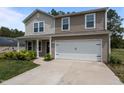 Charming two-story home with a well-manicured lawn and an attached two-car garage at 6007 Austin Falls Ct, Liberty, NC 27298