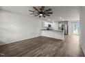 Open-concept living room featuring hardwood floors, modern ceiling fan, and an eat in kitchen at 6007 Austin Falls Ct, Liberty, NC 27298