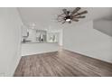 Open-concept living room featuring hardwood floors, modern ceiling fan, and an eat in kitchen at 6007 Austin Falls Ct, Liberty, NC 27298