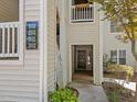 Exterior view of building entrance with unit numbers and a glimpse into the foyer area at 6120 Sunpointe Dr # 102, Raleigh, NC 27606