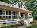 Inviting front porch of single Gathering home featuring fresh white railings and a cozy porch swing at 640 Sagamore Dr, Louisburg, NC 27549