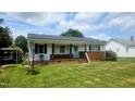 Lovely home with well-maintained lawn, brick accent, and covered parking, offering both curb appeal and convenience at 66 Epsom Rocky Ford Rd, Henderson, NC 27537