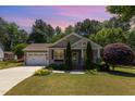 Charming single-story home featuring a manicured lawn and attached two-car garage at 71 Potted Plant Ct, Clayton, NC 27520
