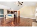 Open living space featuring gleaming hardwood floors, high ceilings, and a view of the kitchen at 71 Potted Plant Ct, Clayton, NC 27520