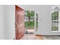 Bright entryway with hardwood floors transitioning to carpet and a view to the outdoors at 7109 Spanglers Spring Way, Raleigh, NC 27610