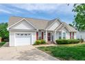 Inviting one-story home with an attached garage, manicured lawn, and lovely curb appeal at 7109 Spanglers Spring Way, Raleigh, NC 27610