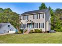 Two-story home with gray siding, black shutters, well-kept lawn and inviting curb appeal at 827 Lockesley Ln, Burlington, NC 27217