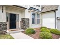 Charming front door with stone accents and lush landscaping for added curb appeal at 912 Beech Glen Dr, Mebane, NC 27302