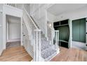 Bright foyer with hardwood floors, staircase, and green mudroom storage at 1009 Sarazen Dr, Clayton, NC 27527