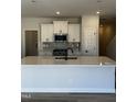 Bright kitchen features an island with quartz countertops and white cabinets at 1010 Westerland Way # 200, Durham, NC 27703