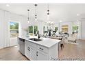 Open-concept kitchen and living area filled with natural light, showcasing modern finishes and a dining space at 103 Mable Ct # 25P, Lillington, NC 27546
