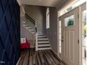 Inviting entryway with stylish floors, staircase, and decorative accent wall at 1106 Purple Glory Dr, Apex, NC 27502