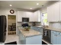 Bright kitchen with island, granite countertops, and modern appliances at 1106 Purple Glory Dr, Apex, NC 27502
