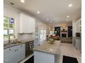 Open kitchen with island that leads to a cozy living room with fireplace at 1106 Purple Glory Dr, Apex, NC 27502