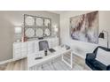 Modern home office with white desk, accent chair, decorative mirror, and stylish decor at 1112 Landen Creek Ln, Zebulon, NC 27597
