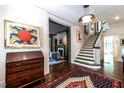 Grand foyer featuring hardwood floors, elegant staircase, and classic decor with eye-catching artwork at 117 Hillcrest Rd, Raleigh, NC 27605