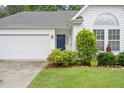 Inviting front entrance with a dark blue front door, white siding, and lush landscaping at 1408 Fairmont St, Durham, NC 27713