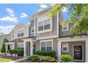 Inviting townhome with neutral siding, white trim, and a well-maintained front yard with lush greenery at 1710 Grace Point Rd, Morrisville, NC 27560