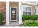Inviting front entrance with a Welcome sign, decorative wreath, and fresh landscaping at 1710 Grace Point Rd, Morrisville, NC 27560