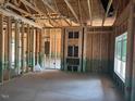 Living room framing featuring an electric fireplace, wiring, and a window at 214 Green Pines Estates Dr, Kenly, NC 27542