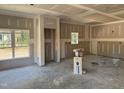 Spacious living room showing drywall, natural light from windows, and an open floor plan during construction at 214 Green Pines Estates Dr, Kenly, NC 27542